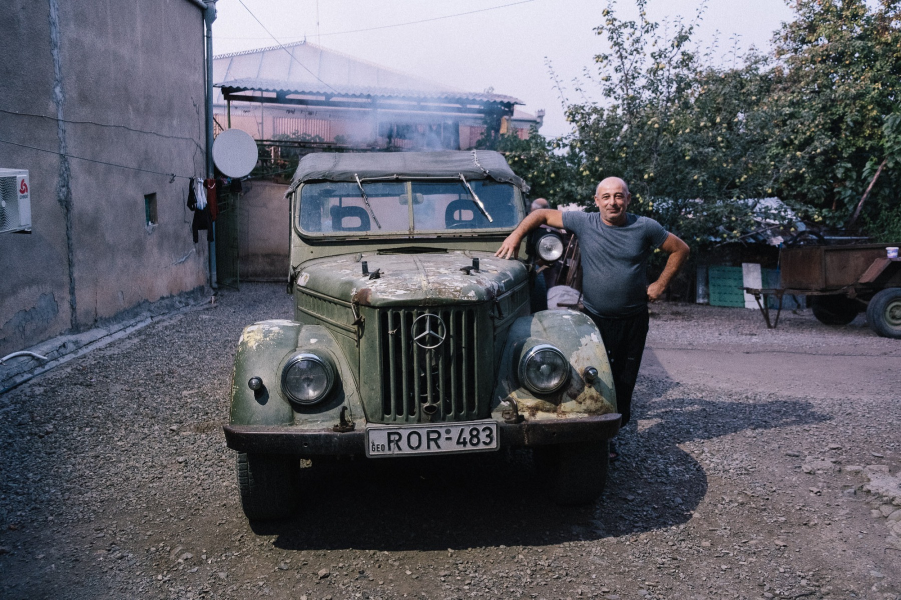 Man proudly showing his old Mercedes in Georgia