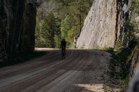 Sabina Knezevic from Farawayistan gravel cycling on a gravel road in Dalsland