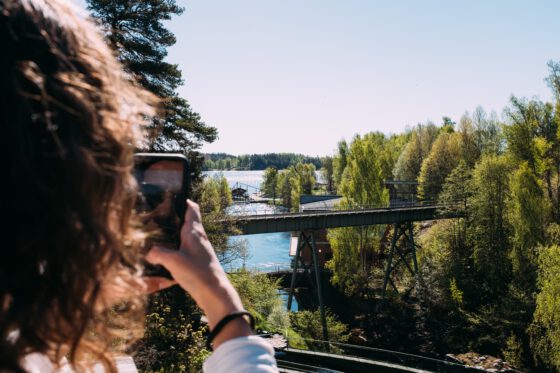 Tourist taking iPhone photo at Dalsland aqueduct