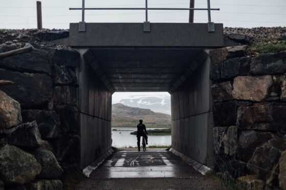 Sheltering from the rain under a tunnel when cycling the Rallarvegen with Glaciers in the background