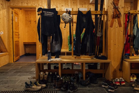 Cycling clothes from Pas Normal Studios hanging out to dry in a ski cabin entrance