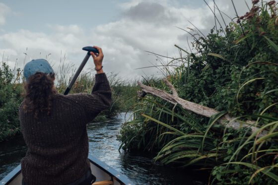 Canoe paddling through lush Swedish countryside
