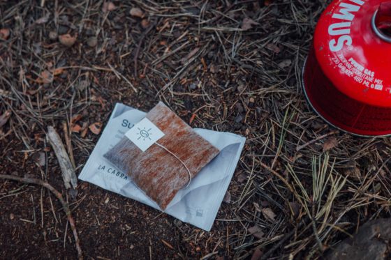 Steeped La Cabra coffee bag in a mug on a camping stove