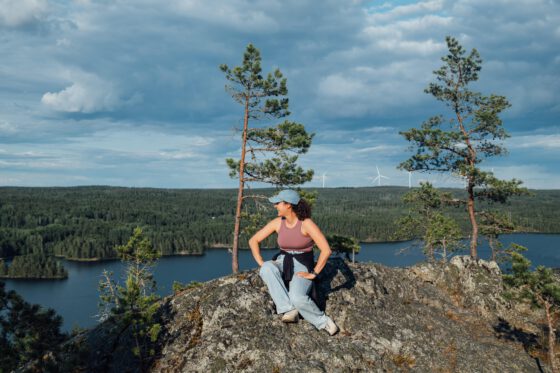 Sabina at a viewpoint on Sörknatten trail, surrounded by forest and lake views in Dalsland