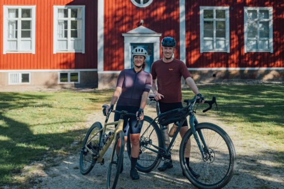 Robin and Sabina of Farawayistan standing with their bikes in front of Nordic Refuge in Dalsland, Sweden