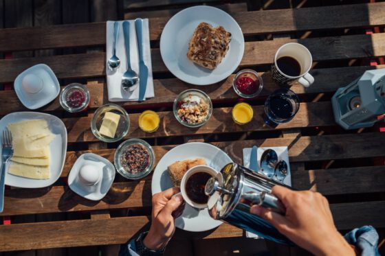 Scandinavian breakfast at Nordic Refuge with coffee, yoghurt topped with granola, and fresh orange juice